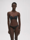Model wearing 'Essentiel' Black Multi-Position Strapless Bra, by Simone Pérèle (front view).