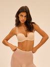 Model wearing 'Essentiel' Pale Pink Multi-Position Strapless Bra, by Simone Pérèle (front view)