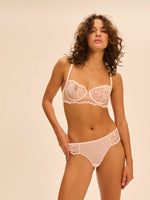 Model wearing 'Intrigue' Pale Pink Tanga, by Simone Pérèle (front view).