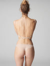 Model wearing 'Karma' Pale Pink Tanga, by Simone Pérèle (back view).