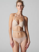 Model wearing 'Karma' Pale Pink Tanga, by Simone Pérèle (front view).