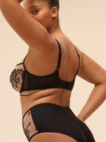 Fuller-figured model wearing 'Romance' Dark Brown Underwired Plunge Bra, by Simone Pérèle (side view).