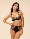 Model wearing 'Romance' Dark Brown Deep Brief, by Simone Pérèle (front view).