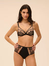 Model wearing 'Romance' Dark Brown Deep Brief, by Simone Pérèle (front view).