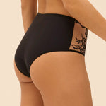 Model wearing 'Romance' Dark Brown Deep Brief, by Simone Pérèle (side view, close up).