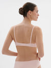 Model wearing 'Saga' Pale Pink Half Cup Bra, from Simone Pérèle (back view).