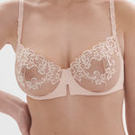 Model wearing 'Saga' Pale Pink Half Cup Bra, from Simone Pérèle (front view, close up).