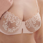 Model wearing 'Saga' Pale Pink Half Cup Bra, from Simone Pérèle (front view, close up).