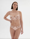 Model wearing 'Saga' Pale Pink Half Cup Bra, from Simone Pérèle (front view).