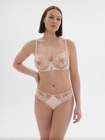 Model wearing 'Saga' Pale Pink Half Cup Bra, from Simone Pérèle (front view).
