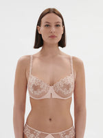 Model wearing 'Saga' Pale Pink Half Cup Bra, from Simone Pérèle (front view).