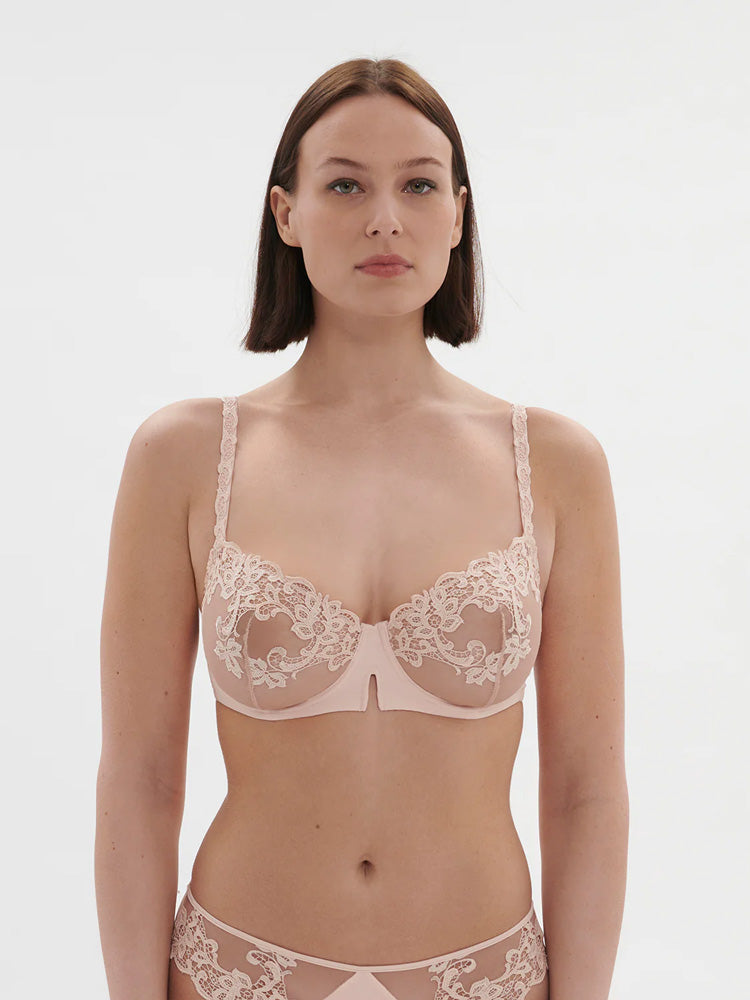 Model wearing 'Saga' Pale Pink Half Cup Bra, from Simone Pérèle (front view).