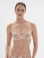 Model wearing 'Saga' Pale Pink Half Cup Bra, from Simone Pérèle (front view).
