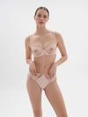 Model wearing 'Saga' Pale Pink Half Cup Bra, from Simone Pérèle (front view).