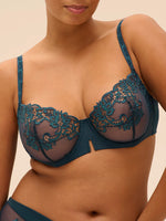 Model wearing 'Saga' Teal Half Cup Bra, by Simone Pérèle (front view).