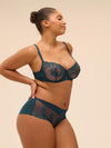 Model wearing 'Saga' Teal Half Cup Bra, by Simone Pérèle (side view).