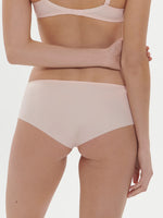 Model wearing 'Saga' Pale Pink Shorty, by Simone Pérèle (back view).