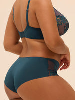 Model wearing 'Saga' Teal Shorty, by Simone Pérèle (back/side view).