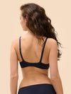Model wearing 'Wish' Midnight Blue Underwired Full Cup Plunge Bra, by Simone Pérèle (back view).