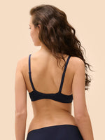 Model wearing 'Wish' Midnight Blue Underwired Full Cup Plunge Bra, by Simone Pérèle (back view).