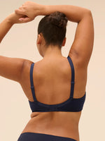 Plus size model wearing 'Wish' Midnight Blue Underwired Full Cup Plunge Bra, by Simone Pérèle (back view).