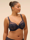 Plus size model wearing 'Wish' Midnight Blue Underwired Full Cup Plunge Bra, by Simone Pérèle (front view).