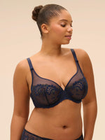 Plus size model wearing 'Wish' Midnight Blue Underwired Full Cup Plunge Bra, by Simone Pérèle (front view).