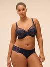 Plus size model wearing 'Wish' Midnight Blue Underwired Full Cup Plunge Bra, by Simone Pérèle (front view).