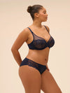 Plus size model wearing 'Wish' Midnight Blue Brief, by Simone Pérèle  (side view).