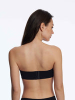 Model wearing 'Breathless' Black Strapless Plunge Push-up Bra, by Skarlett Blue (back view).