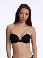 Model wearing 'Breathless' Black Strapless Plunge Push-up Bra, by Skarlett Blue (front view).