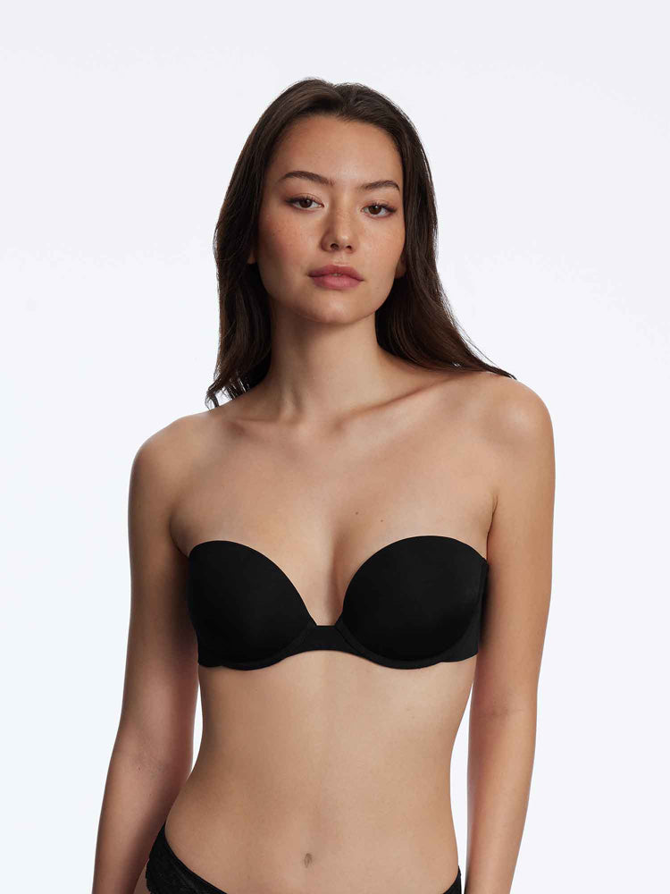 Model wearing 'Breathless' Black Strapless Plunge Push-up Bra, by Skarlett Blue (front view).