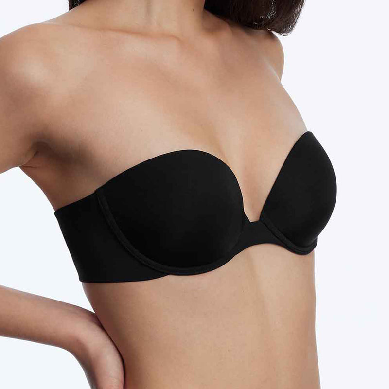 Model wearing 'Breathless' Black Strapless Plunge Push-up Bra, by Skarlett Blue (side view, close up).