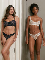 Model (on left) wearing 'Entice' Midnight Blue and Black Thong, by Skarlett Blue (front view).